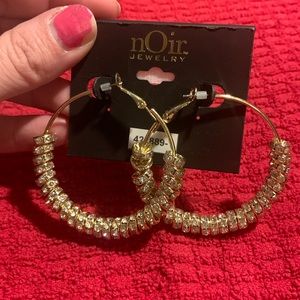 Noir jewelry gold hoop earrings with circles of gemstones.